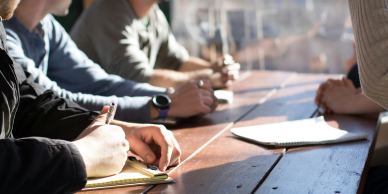 Image of people sitting at a table with documents.