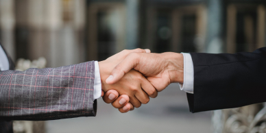 Image of 2 people shaking hands.