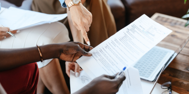 2 people reviewing a document.